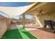 Covered patio with a view of the pool and a grill, ideal for outdoor entertaining at 9331 W Harmony Ln, Peoria, AZ 85382