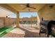 Covered patio provides a shaded view of the pool area with a grill for outdoor cooking at 9331 W Harmony Ln, Peoria, AZ 85382