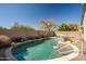 Backyard pool offers a tranquil oasis with mature trees and a serene atmosphere at 9331 W Harmony Ln, Peoria, AZ 85382