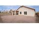 Expansive backyard with a covered patio, block wall, and potential for landscaping at 1009 E Brentrup Dr, Tempe, AZ 85283