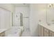 Bright bathroom featuring a soaking tub, shower, and a vanity with sink and storage at 1009 E Brentrup Dr, Tempe, AZ 85283