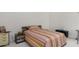 Bright bedroom with a comfortable bed and simple decor and neutral colored walls at 1009 E Brentrup Dr, Tempe, AZ 85283