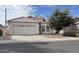 Tan single-story home featuring a two-car garage and tile roof in a quiet neighborhood at 1009 E Brentrup Dr, Tempe, AZ 85283
