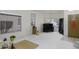 Minimalist living room design with white walls and tile flooring at 1009 E Brentrup Dr, Tempe, AZ 85283