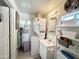 A compact bathroom with toilet, sink, mirror, storage, and stacked washer dryer unit at 1027 S Prospector Dr, Apache Junction, AZ 85119