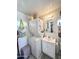 Bathroom including a sink, toilet, and stacked washer and dryer at 1027 S Prospector Dr, Apache Junction, AZ 85119