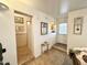 Bright foyer featuring neutral tile flooring, a small decorative table, and entry to kitchen at 1027 S Prospector Dr, Apache Junction, AZ 85119