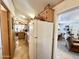 Efficient kitchen space with a white refrigerator and view into the living area at 1027 S Prospector Dr, Apache Junction, AZ 85119