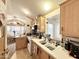 This charming kitchen overlooks the dining area, and features white appliances at 1027 S Prospector Dr, Apache Junction, AZ 85119
