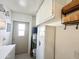Bright laundry room offers ample storage space with white cabinets and shelving for organization and easy access to the outside at 1027 S Prospector Dr, Apache Junction, AZ 85119