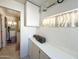 A laundry room with storage cabinets, long countertop and view into the washroom area at 1027 S Prospector Dr, Apache Junction, AZ 85119