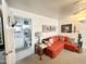 Living room featuring an orange sofa, leading into the bathroom and other living spaces at 1027 S Prospector Dr, Apache Junction, AZ 85119