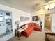 Living room featuring an orange sofa with a view of the bathroom and entryway at 1027 S Prospector Dr, Apache Junction, AZ 85119