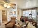 Bright living room with ceiling fan, large windows, and casual seating arrangement at 1027 S Prospector Dr, Apache Junction, AZ 85119