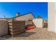 A backyard with gravel, fence, and storage for kayaks and other outdoor equipment at 1027 W Natal Ave, Mesa, AZ 85210
