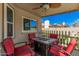 Cozy covered patio with comfortable chairs, a fire pit table, and a view of the backyard at 1027 W Natal Ave, Mesa, AZ 85210