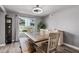 Cozy dining room featuring a modern light fixture, natural light, and neutral decor at 1027 W Natal Ave, Mesa, AZ 85210