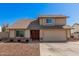 Two-story tan home featuring a two-car garage and a well-kept, low-maintenance front yard at 1027 W Natal Ave, Mesa, AZ 85210
