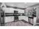 Updated kitchen features stainless steel appliances and gray granite countertops at 1027 W Natal Ave, Mesa, AZ 85210