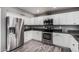 Bright kitchen boasts stainless steel appliances, sleek countertops, and white cabinets at 1027 W Natal Ave, Mesa, AZ 85210
