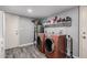 Updated laundry room featuring a two washers, updated flooring and a folding shelf at 1027 W Natal Ave, Mesa, AZ 85210