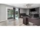Cozy living room with a decorative fireplace and sliding doors to backyard pool at 1027 W Natal Ave, Mesa, AZ 85210
