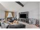 A neutral toned living room, with high ceilings, a large comfortable sofa, and a modern entertainment center at 1027 W Natal Ave, Mesa, AZ 85210