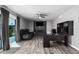Spacious living room features modern ceiling fan, recessed lighting, fireplace, and desk at 1027 W Natal Ave, Mesa, AZ 85210