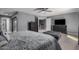 Comfortable main bedroom with ceiling fan, television, and ensuite bathroom in neutral gray tones at 1027 W Natal Ave, Mesa, AZ 85210