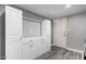 This mudroom features built-in cabinets and drawers for storage, as well as a hanging rack and wood-look floors at 1027 W Natal Ave, Mesa, AZ 85210