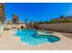 Backyard featuring diving board, private pool, spa, rock waterfall feature, tropical landscaping, and comfortable seating at 1027 W Natal Ave, Mesa, AZ 85210