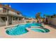 Spacious backyard featuring a diving board, pool, spa, rock waterfall feature, lounge chairs and tropical landscaping at 1027 W Natal Ave, Mesa, AZ 85210