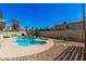 Backyard featuring a private pool, spa, rock waterfall feature, lounge chairs and tropical landscaping at 1027 W Natal Ave, Mesa, AZ 85210