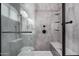 Glass enclosed shower with bench and shelving featuring sleek, modern black hardware at 1027 W Natal Ave, Mesa, AZ 85210
