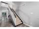 Carpeted staircase with painted dark wood trim and gray walls leads to upper level at 1027 W Natal Ave, Mesa, AZ 85210