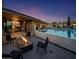 Stunning backyard with fire pit, outdoor seating, and a gorgeous pool with water features at 10381 E Loving Tree Ln, Scottsdale, AZ 85262