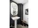 Stylish powder room featuring a pedestal sink, unique lighting, and modern finishes at 10381 E Loving Tree Ln, Scottsdale, AZ 85262