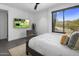 Bright bedroom featuring a modern aesthetic, comfortable bed, and a stunning outdoor view at 10381 E Loving Tree Ln, Scottsdale, AZ 85262