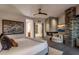 Bright bedroom featuring a stone fireplace, comfortable bed and a modern aesthetic at 10381 E Loving Tree Ln, Scottsdale, AZ 85262