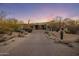 Desert landscaped front yard with native plants and a long driveway leading to the home at 10381 E Loving Tree Ln, Scottsdale, AZ 85262