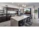 Spacious kitchen with a large island, bar seating, and views of the outdoor patio at 10381 E Loving Tree Ln, Scottsdale, AZ 85262