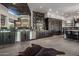 Entertainer's kitchen features stainless steel appliances, custom cabinets, and bar at 10381 E Loving Tree Ln, Scottsdale, AZ 85262