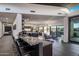 Open-concept kitchen offers seating at the island bar and views of the living area at 10381 E Loving Tree Ln, Scottsdale, AZ 85262