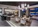 Open living space with dark wood ceilings, access to the kitchen, and backyard at 10381 E Loving Tree Ln, Scottsdale, AZ 85262