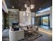 Open-concept living room with stone fireplace, accent lighting, and mountain views at 10381 E Loving Tree Ln, Scottsdale, AZ 85262