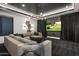 Media room featuring a sectional sofa, projector screen, and dimmable lighting at 10381 E Loving Tree Ln, Scottsdale, AZ 85262