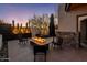 Outdoor patio with a fire pit, modern seating, and desert landscaping at 10381 E Loving Tree Ln, Scottsdale, AZ 85262