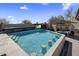 Outdoor pool with a swim-up bar, waterfall feature, and outdoor television with a desert setting at 10381 E Loving Tree Ln, Scottsdale, AZ 85262