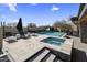 Backyard pool and spa area featuring outdoor seating, desert landscaping, and steps leading to a relaxing retreat at 10381 E Loving Tree Ln, Scottsdale, AZ 85262
