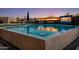 Backyard pool area features a built-in fire pit, waterfall features, and an outdoor television at 10381 E Loving Tree Ln, Scottsdale, AZ 85262